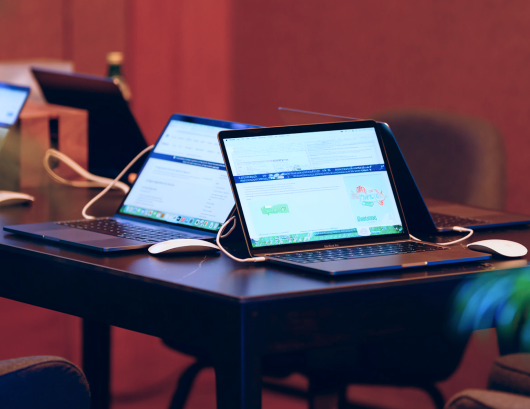 MacBook Pro laptops set up for business meetings, training sessions, and corporate events